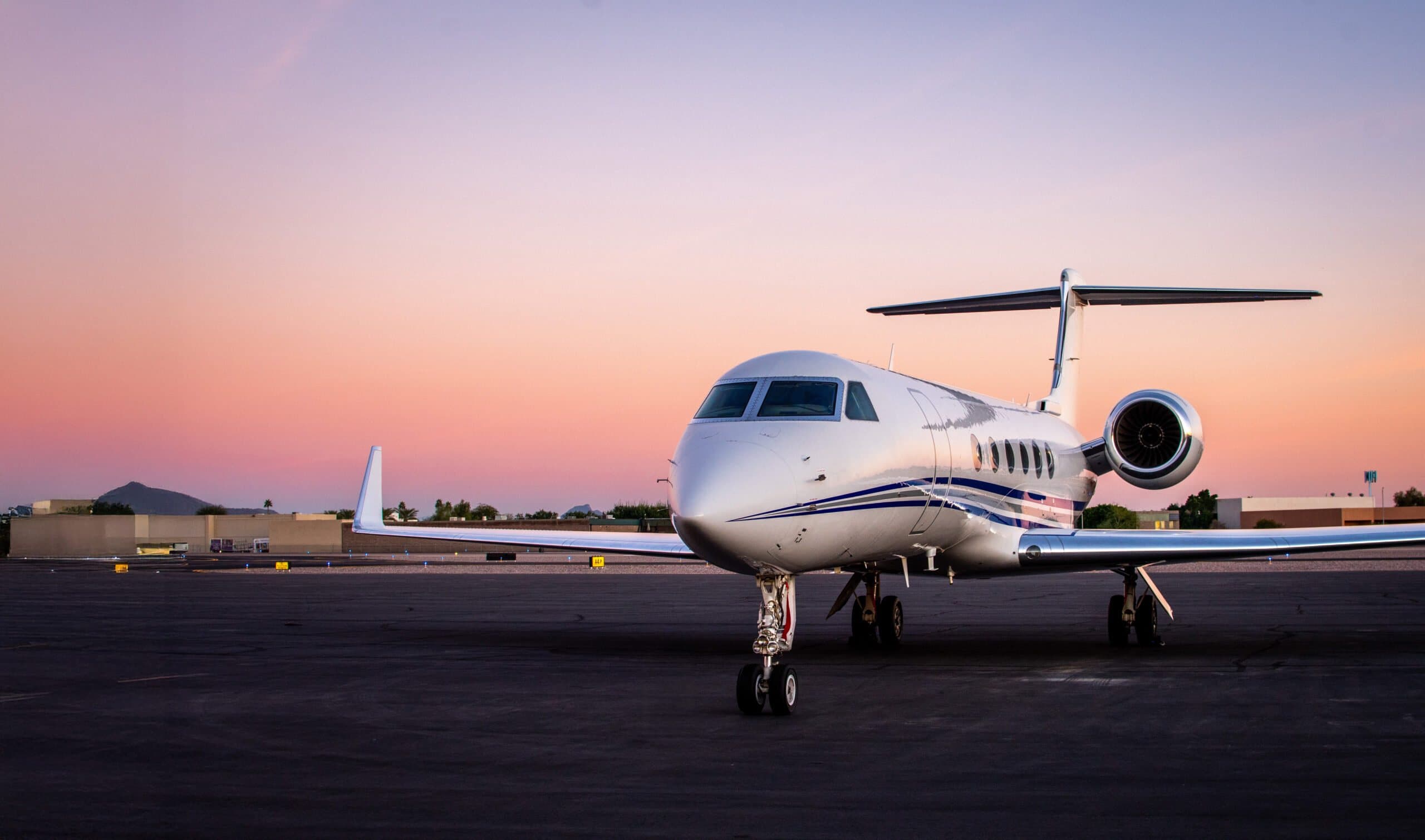 A private jet on the apron at sunset